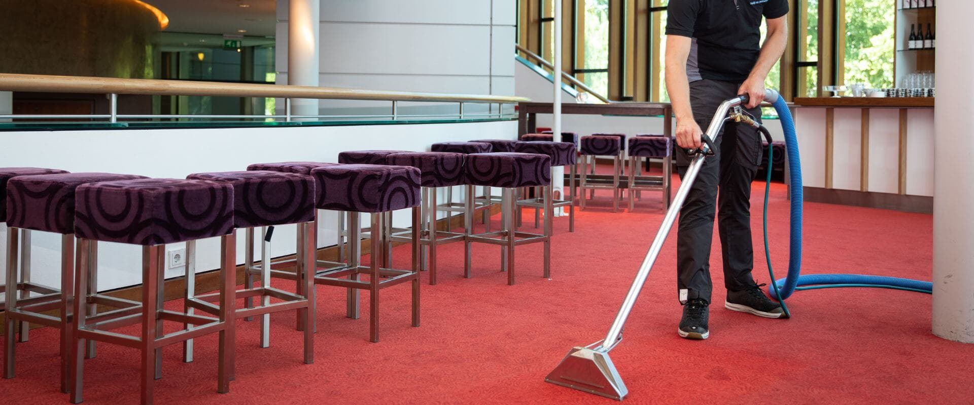 Specialist reinigt tapijt in professionele omgeving